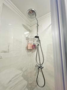 a shower with a shower head in a bathroom at Studio 118 - A luxury place,Self Check-in ,10 min from City Center in Timişoara