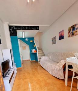 a living room with a couch and a tv at Sunflower Playa Lisa in Santa Pola