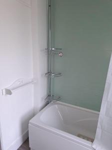 a white bath tub in a bathroom with a shower at Luxury Double Room near London Seven Kings Train Station in Seven Kings