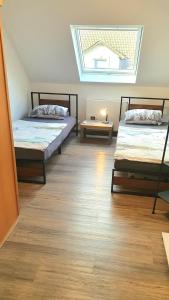 two beds in a room with a skylight at FRANKES SLEEP INN, 2 Wohnungen 2 Betten und 5 Betten, Sauna in Velbert