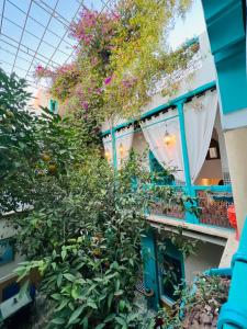 a building with a bunch of plants on a balcony at Riad Al Nour in Marrakech