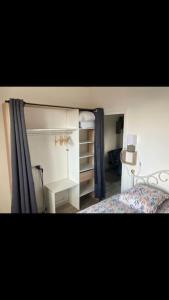 a bedroom with a bed and a dresser in it at Studio « Bâbord » Le Tréport - vue mer & falaises in Le Tréport