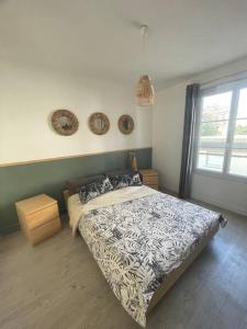 a bedroom with a large bed and a window at Calme - Balcon - 2 à 4 pers - WIFI - plage à 100m in Berck-sur-Mer