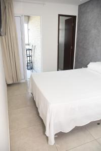 Katil atau katil-katil dalam bilik di Apartamento na Praia do Francês