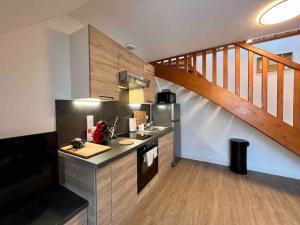 a kitchen with a counter and a staircase at Appartement Centre-ville / 6 prsn / Bord du doubs / Au pied de la citadelle in Besançon