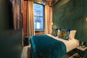 a bedroom with a large bed with a window at Forty-Seven in Manchester
