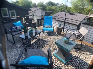 an outdoor patio with blue chairs and a table at East Austintacious: walkable airy arty 4 bedroom 3 1/2 bath in Austin