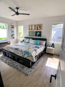 a bedroom with a bed and a ceiling fan at East Austintacious: walkable airy arty 4 bedroom 3 1/2 bath in Austin