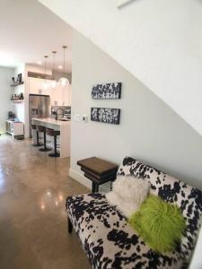 a living room with a couch and a table at East Austintacious: walkable airy arty 4 bedroom 3 1/2 bath in Austin