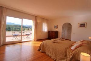 a bedroom with a large bed and a large window at 1175 villa el paraiso in Estepona