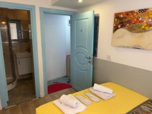 a bedroom with a yellow bed with two towels at Rodin Hostel in Istanbul
