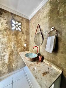 uma casa de banho com um lavatório e um espelho em Suíte em Sítio a 5 minutos da praia em Porto Seguro