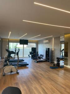 a gym with treadmills and cardio equipment in a room at Acquarius Residence Vista Mar in Fortaleza