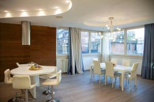 a dining room with a white table and chairs at ROME Chic and Elegant Apartment near METRO Station in Rome