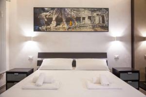 a bedroom with a large white bed with two night stands at ROME Chic and Elegant Apartment near METRO Station in Rome