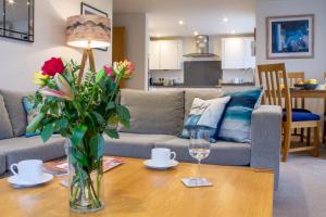 a living room with a vase of flowers on a table at Sea Bleu in St Ives