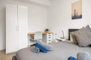 een slaapkamer met een bed, een bureau en een stoel bij Beautiful Ben Yehuda Apartment in Jeruzalem