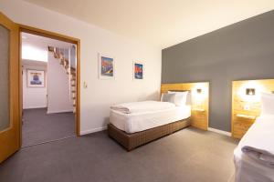 a hotel room with a bed and a staircase at Mittendrin in Garmisch-Partenkirchen