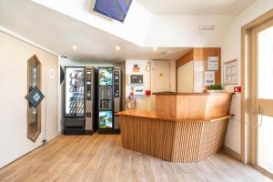 a restaurant with a refrigerator and a counter in a room at My KB Hôtel Montélimar in Saulce-sur-Rhône