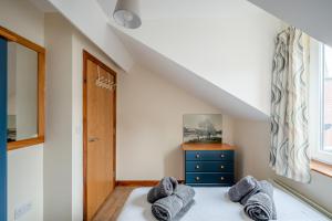 a bedroom with a bed with gray pillows on it at Apartment in city centre, close to bars and resturants in Belfast