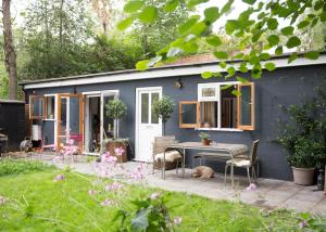 a blue tiny house with a table and chairs at Crescent Lodge, Crouch End, London in London