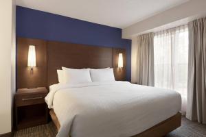 a hotel room with a large bed and a window at Residence Inn by Marriott Chicago / Bloomingdale in Bloomingdale