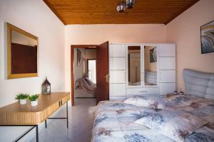 a bedroom with a bed and a table and a desk at Cozy loft apartment in Samos
