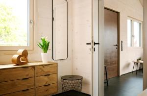 a bathroom with a wooden dresser and a mirror at Ferienwohnung HolzGenuss in Lehrberg