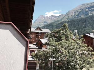 a view of a mountain from a building with a tree at Haus Valesia in Leukerbad
