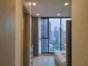 a bedroom with a large window with a city view at Free airport pick-up/Aerial rainforest/Near subway line/Train night market/Central rama 9/Super high-rise luxury apartment/Night view/RCA in Bangkok