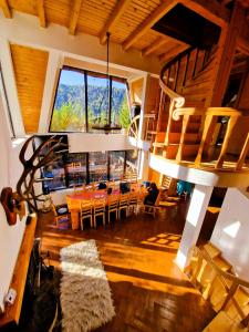 a living room with a staircase and a table and chairs at Acasa La Munte in Azuga