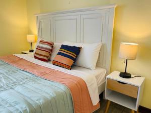 a bedroom with a bed with two pillows on it at The Rainier Bed & Breakfast 3 in San José