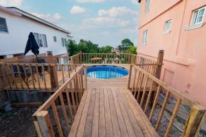 a wooden bridge leading to a swimming pool on a house at Belle Air Seaview- Entire Home (5 Bdrm 5Bath) in Runaway Bay