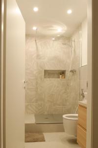 y baño con ducha y aseo. en Appartamento La Chicca en Prato