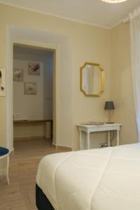 a bedroom with a bed and a table and a mirror at Appartamento La Chicca in Prato +12 photos