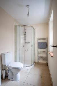 a bathroom with a toilet and a glass shower at Apartment in city centre, close to bars and resturants in Belfast