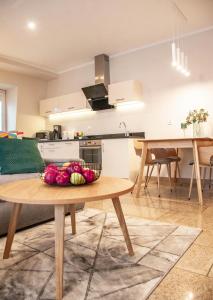 a kitchen with a table with a bowl of fruit on it at Apartamenty na Wyspie - Stella Baltic - Parking in Świnoujście +181 photos
