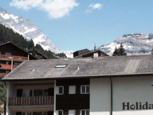 a building with a view of a mountain at Haus Valesia in Leukerbad