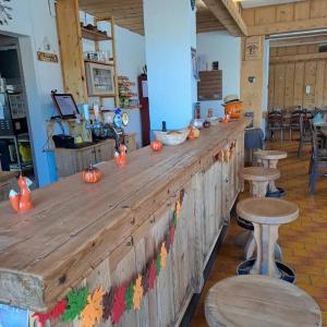 a wooden bar with pumpkins on it in a restaurant at Auberge des Charmettes, chez Chantal et Yves in Bourg-Saint-Pierre