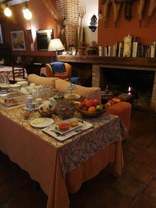 a table with food and a bowl of fruit on it at La Casona del Abuelo Parra in Villanueva de los Infantes