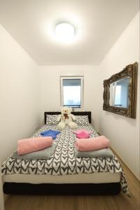 a bedroom with a teddy bear sitting on a bed at Apartman MRL Cavic in Banja Luka
