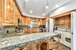 a kitchen with wooden cabinets and a granite counter top at Tahoe Cozy Cabin, 2 Bedroom with a gas fireplace. in South Lake Tahoe