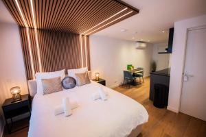 a bedroom with a large white bed with white pillows at Luxurious 35m2 Designer Studio - R51A in Eindhoven