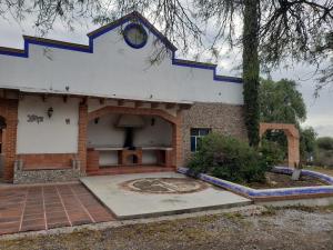 a building with a clock on the side of it at Peña de Bernal Rancho La Trinidad in Cerrito