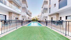 a swimming pool in the middle of a building at Arenales Paradise with Pool AC Balcony and Terrace in Arenales del Sol