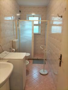 a bathroom with a shower and a toilet and a sink at Casa Licanio in Bibione