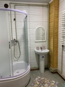 a bathroom with a tub and a sink and a shower at Шпінь 2 in Vorokhta +59 photos