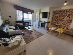 a living room with a couch and a fireplace at APART PL DO PAZO - Sanxenxo in Sanxenxo