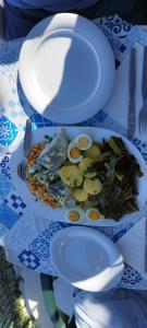 a plate of food with eggs and vegetables on a table at Paisagem do Guadiana Turismo Rural in Odeleite