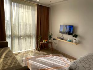 a living room with a large window and a television at studio unit whit pool and gym in Istanbul
